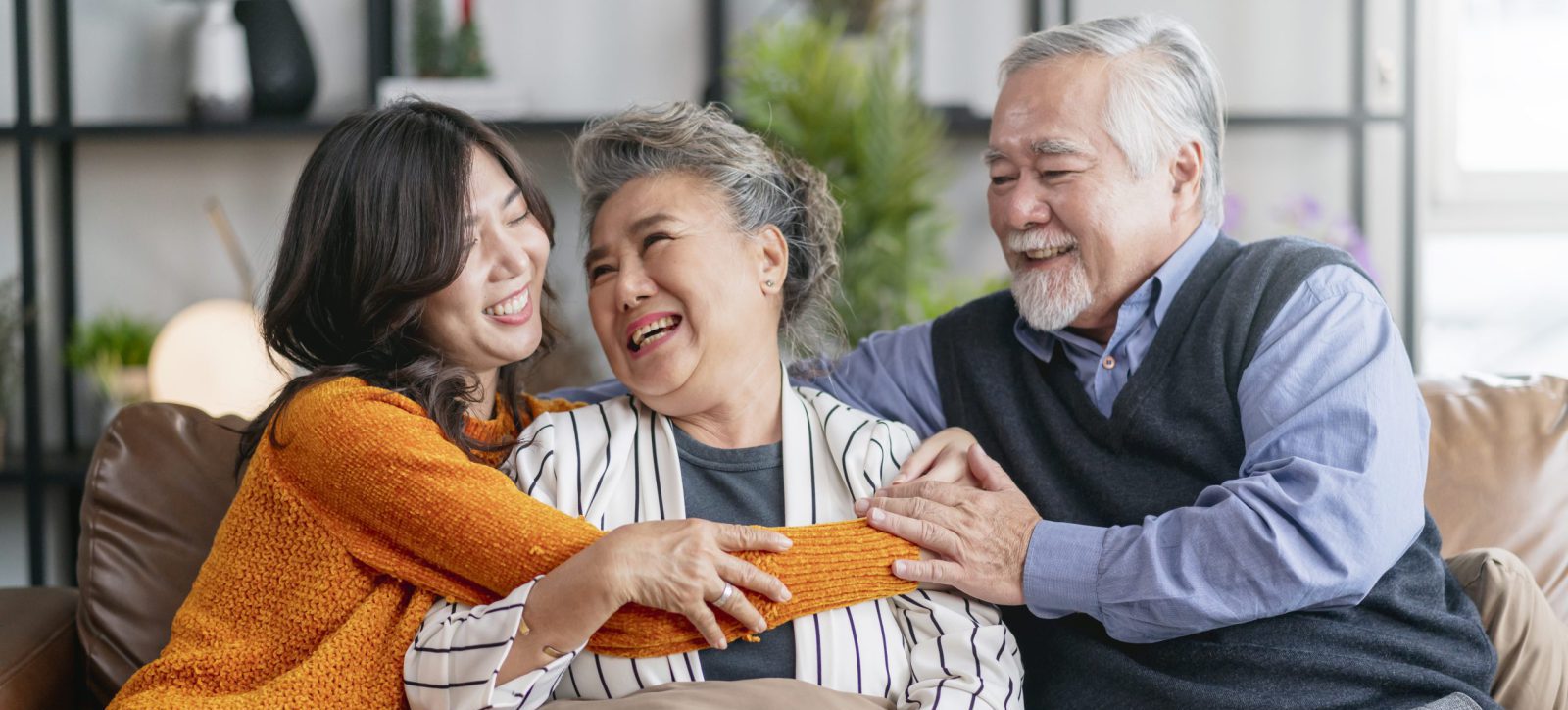 happiness-asian-family-candid-daughter-hug-grandparent-mother-farther-senior-elder-cozy-relax-sofa-couch-surprise-visiting-living-room-hometogether-hug-cheerful-asian-family-home